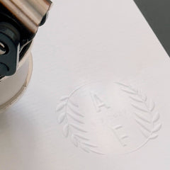 Dry stamp with initial ornaments