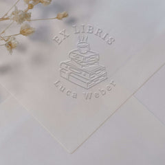 Bookplate embosser, pile of books, coffee