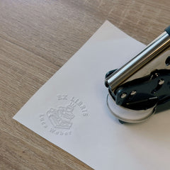 Bookplate embosser, pile of books, coffee