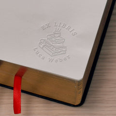 Bookplate embosser, pile of books, coffee