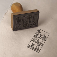 Ex-libris stamp, well-stocked shelf