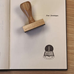 Ex-libris stamp, book and candle