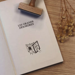 Ex-libris stamp: hands holding a book