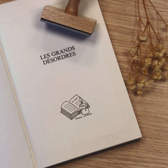 Ex-libris stamp in front of book